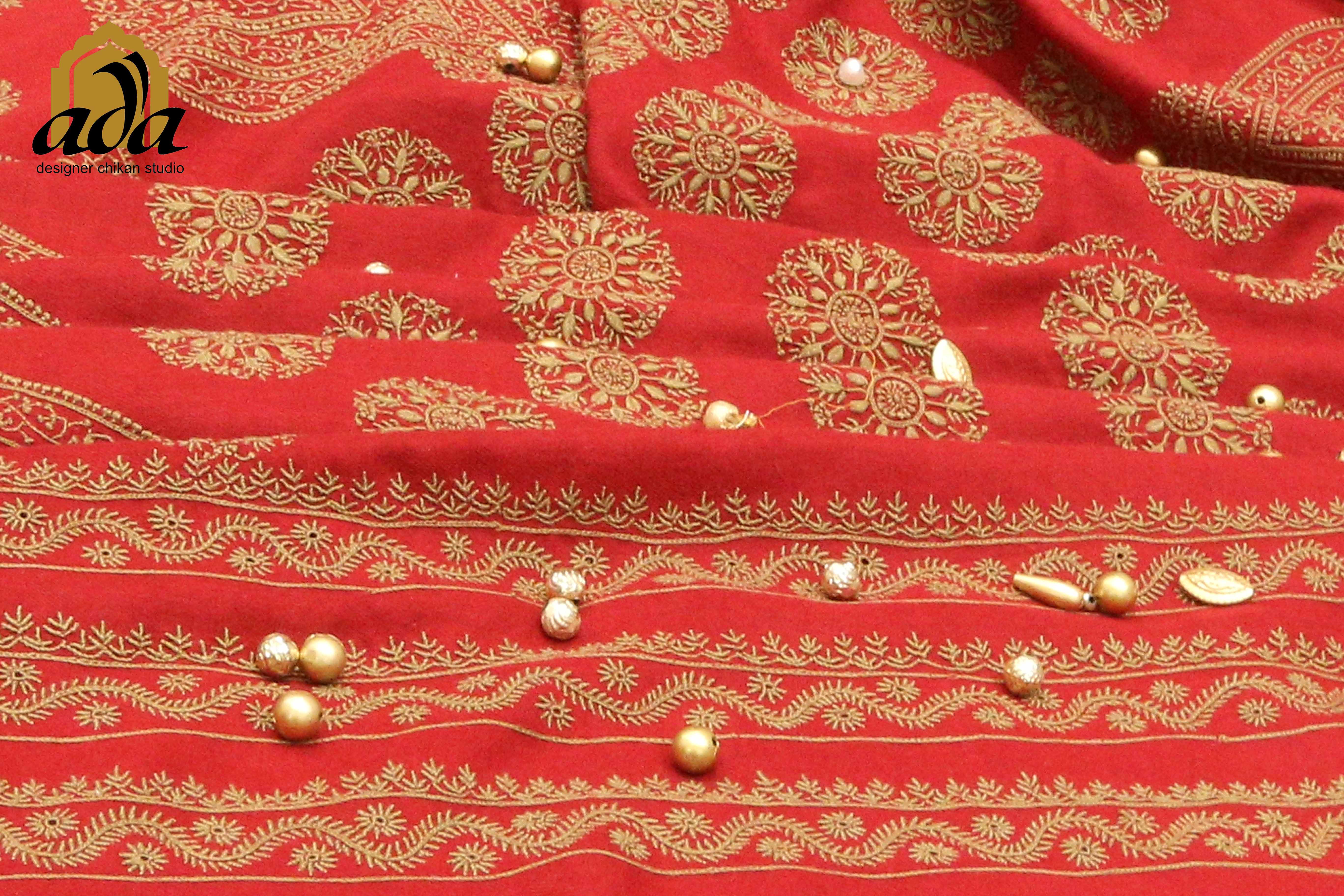 Fine chikankari stitches shown on kashmir's pashmina in briht cherry red shawl adorned with cream color pearls